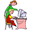 Stangin lady pointing to monitor, seated boy typing